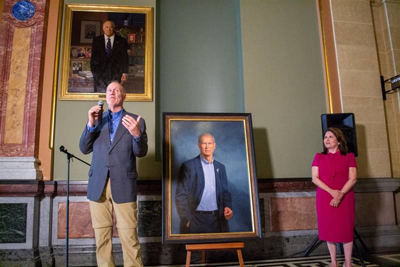 Former Gov. Bruce Rauner, now a Florida resident, unveils his official portrait before it is hung on the wall of the Illinois State Capitol. Rauner, a Republican, was governor from 2015 until 2019. Pictured above Rauner is the portrait of his predecessor, Democrat Pat Quinn, and at right is his Lt. Gov. Evelyn Sanguinetti.