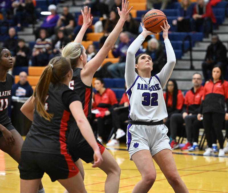Hampshire's Sophie Oleferchik (32) looks to take a shot under heave Palatine pressure during the IHSA Class 4A regional girls basketball semifinal game on Monday, Feb. 12, 2024 in Buffalo Grove.
