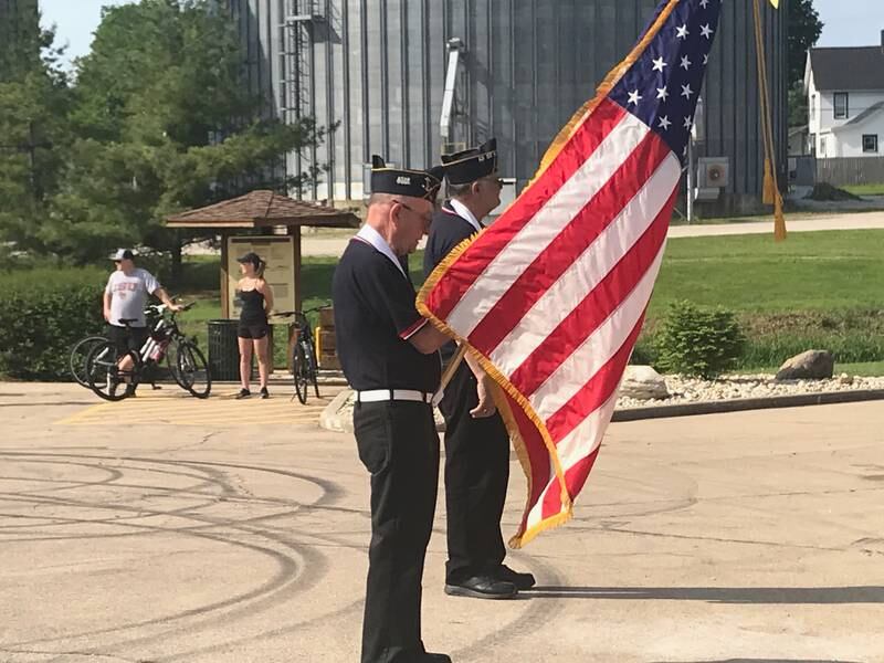 Dan Snell (left) and Joe Bernardoni present the colors at Monday's Memorial Day observances at Danny Carey Memorial in Utica.
