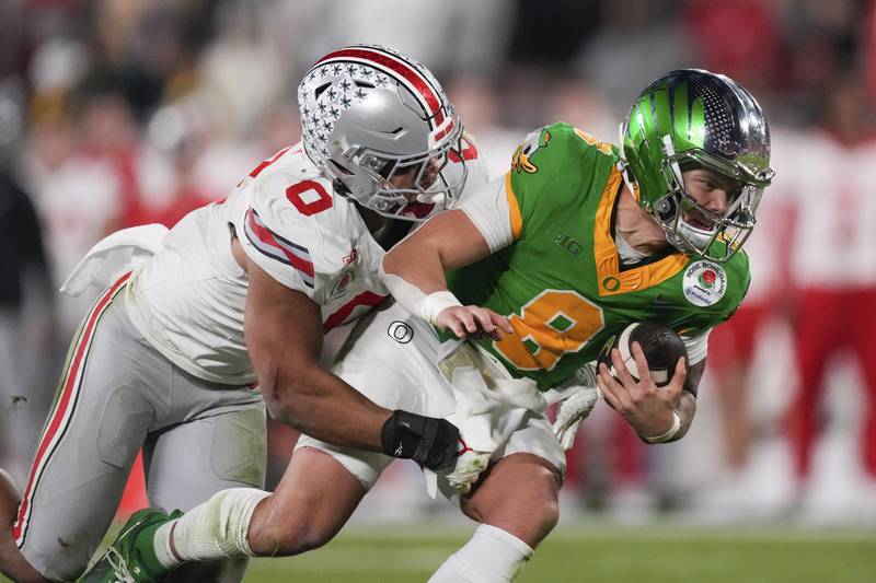 Ohio State linebacker Cody Simon (0) sacks Oregon quarterback Dillon Gabriel (8) during the second half in the quarterfinals of the Rose Bowl College Football Playoff, Wednesday, Jan. 1, 2025, in Pasadena, Calif. (AP Photo/Mark J. Terrill)
