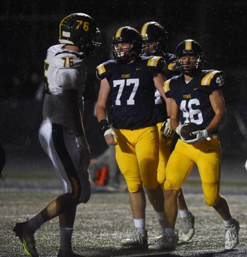 Glenbrook South’s Hank Leahy (46) has the ball after scoring a touchdown during the second quarter of Friday’s game against Glenbrook North.