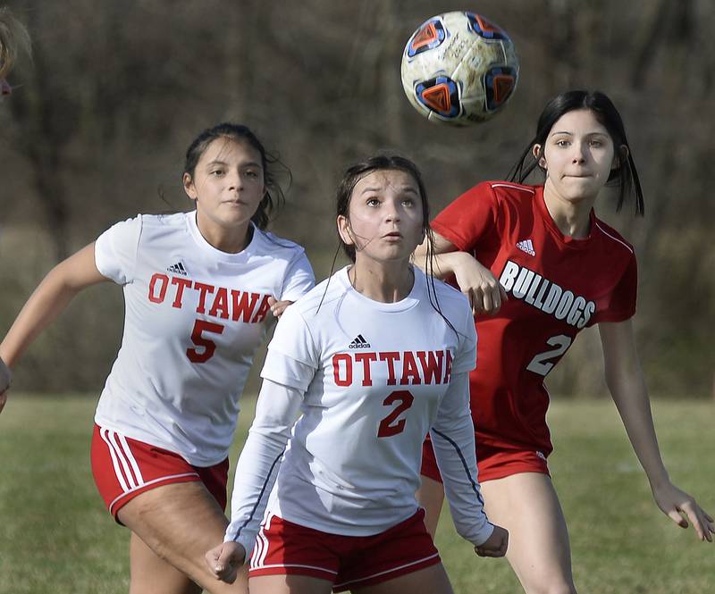 Ottawa’s Yesenia Leon prepares a header in front of Ottawa’s Alejandra Espinoza and Streator’s Addie Lopez on April 1, 2022 during match at Streator.