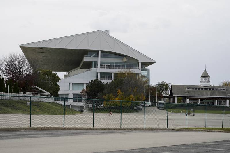The grandstand at Arlington International Racecourse is seen from a parking lot in Arlington Heights, Ill., Friday, Oct. 14, 2022. The Chicago Bears want to turn the Arlington Heights site, once a jewel of thoroughbred racing, into a different kind of gem, anchored by an enclosed stadium and bursting with year-round activity — assuming a deal with Churchill Downs Inc. to buy the land goes through. They envision restaurants, retail and more on the plot of land some 30 miles northwest of their longtime home at Soldier Field — all for about $5 billion, with some taxpayer help. (AP Photo/Nam Y. Huh)