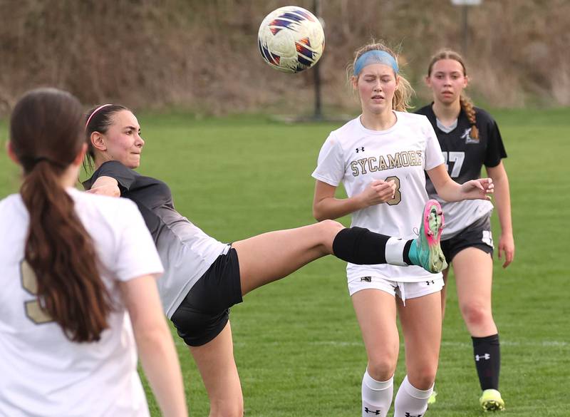 Kaneland's Taylor Mills kicks the ball in front of Sycamore's Marin Gautcher during their game Monday, April 13, 2026, at Kaneland High School.
