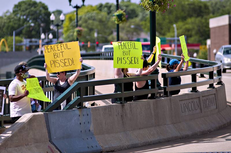 Protesters line Galena Avenue Bridge in Dixon Monday to show their frustration on the killing of George Floyd.