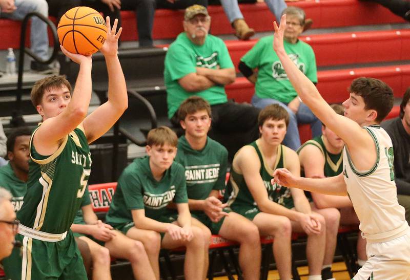St. Bede's Halden Hueneburg shoots a jump shot over Eureka's Connell Roth during the 50th annual Colmone Classic on Monday, Dec. 9, 2024 at Hall High School.