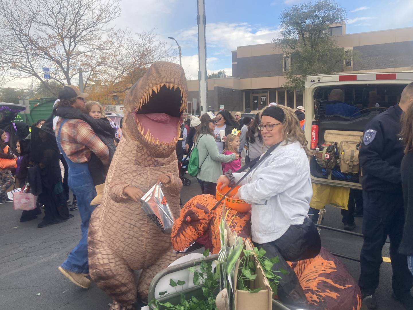 A t-rex receives candy from a velociraptor at the Jurassic Park trunk. 
Saturday, Oct. 25, 2025.