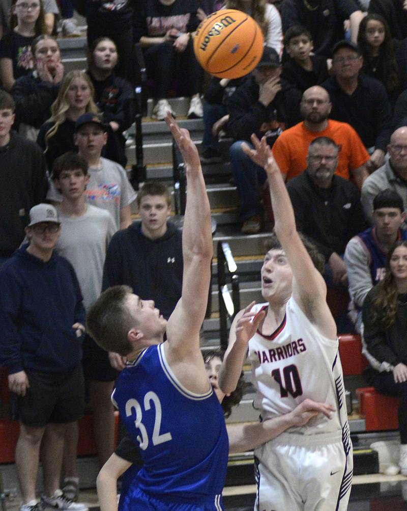 Woodland’s Jaron Follmer gets this shot past the block attempt by Newark’s Cody Kulbartz in the 4th period Friday at the Woodland Regional.