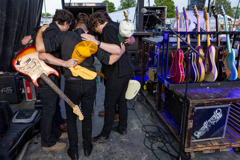 Timothy Wayne, and his band huddle in prayer prior to going on stage at the Marshall Putnam Fair on June 17, 2025 in Henry Illinois.