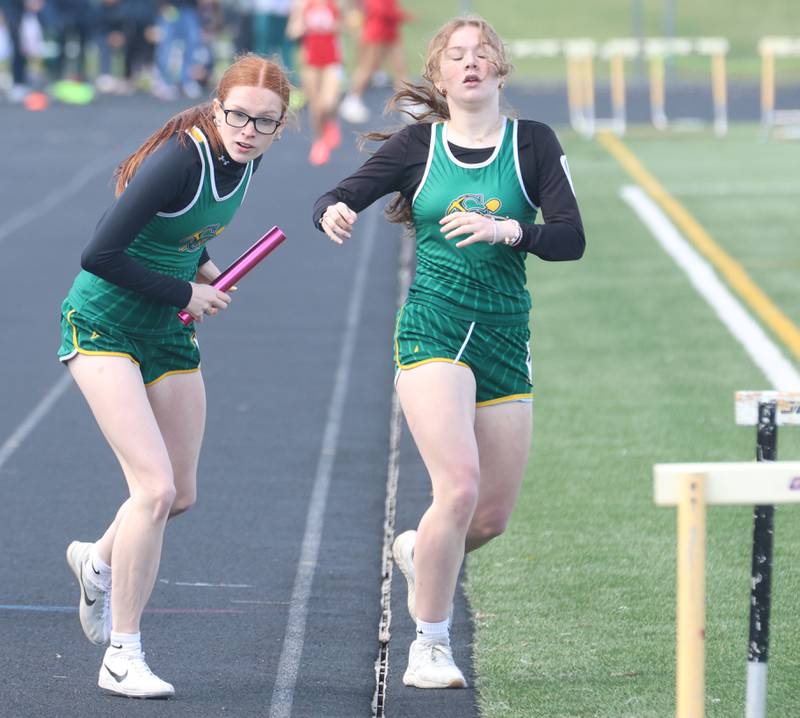 Coal City's Hope Wermer gets the baton from Lana Larsen during the Class 2A Sectional track meet on Wednesday, May 13, 2026 in the Jeff Prusator Athletic Complex at Mendota High School.