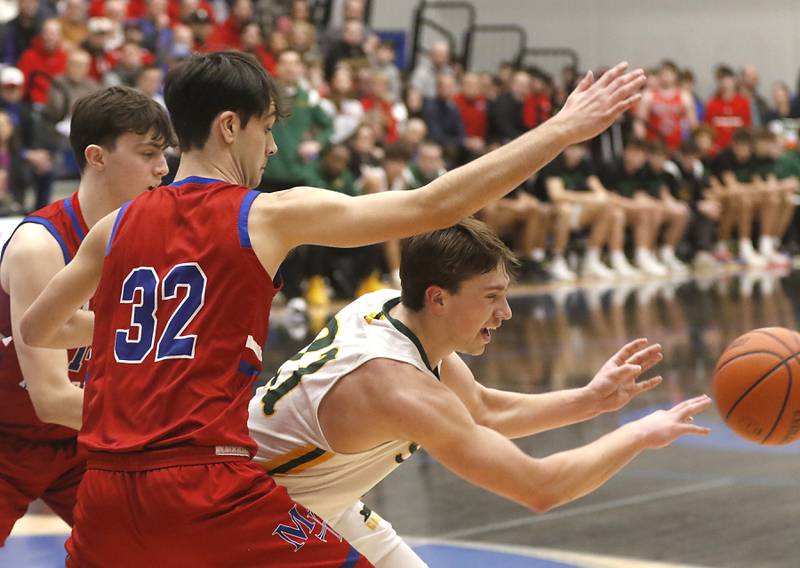 Crystal Lake South's Cooper LePage passes out of the the defense of Marmion’s Henry Dalmann, (center) and Evan Stumn during a IHSA Class 3A Sectional boys basketball game Tuesday, Feb. 28, 2023, at Central High School in Burlington.