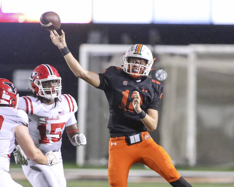 Plainfield East's Brady Cloherty (12) unleashes a pass while under pressure during football game between Yorkville at Plainfield East Friday, Sept 19, 2025 in Plainfield.
