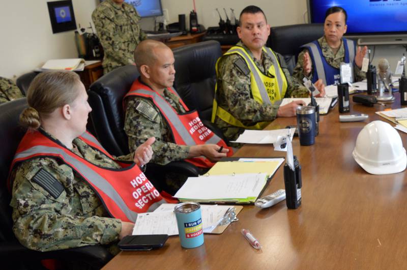 From one side of the vast Pacific to the other…Cmdr. Katharine Mangan, a Barrington, Illinois native, (far left) currently assigned back in the Pacific Northwest for her second time at NHB/NMRTC Bremerton as director of medical services, distinguished herself when stationed at U.S. Navy Medicine Readiness Training Command Yokosuka for her Continuous Process Improvement submission in the Define-Measure-Analyze-Improve-Control (DMAIC) category, “Reduce Delay in Vitamin D Deficiency Diagnosis.” Her efforts led to identifying and correcting several issues which contributed to delays for surgery patients, including an inefficient surgical consent process, delays in surgical site preparation, and lack morning safety huddle time standards. With Mangan implementing needed corrections to streamline their process safely and effectively, first patient surgical suite results in room time compliance increased from 34 percent to 90 percent (Official Navy photo by Douglas H Stutz, NHB/NMRTC Bremerton public affairs officer).