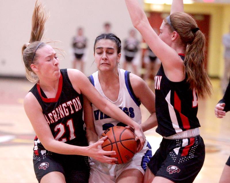Geneva’s Leah Palmer (center) holds onto the ball against Barrington’s Sarah Bauernfreund (left) and Ashley Mahlum (right) during the Class 4A Schaumburg Supersectional on Monday, Feb. 27, 2023.