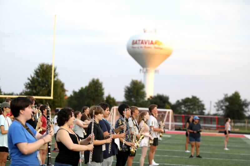 Members of the Batavia High School marching band walk through their choreography with their instruments during band camp at the school on Tuesday, July 30, 2024.