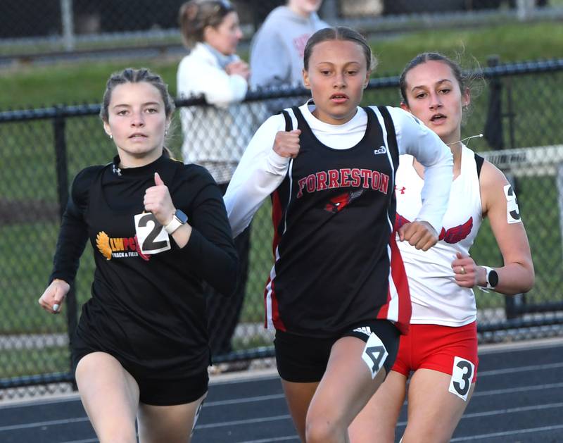 Forreston-Polo's Tenlei Patterson (center) and Oregon's Anya Anaya (right) chase Lena-Winslow's Lila Grindey on the final curve of the 800 meters at the 1A Winnebago Sectional on Wednesday, May 13, 2026. All three advanced to the state meet.