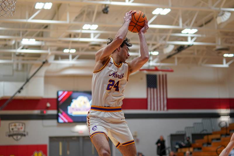 Downers Grove North's Aidan Akkawi (24) rebounds the ball during a Batavia Night of Hoops Basketball game against Oswego East at Batavia High School on Saturday, Jan. 25, 2025.