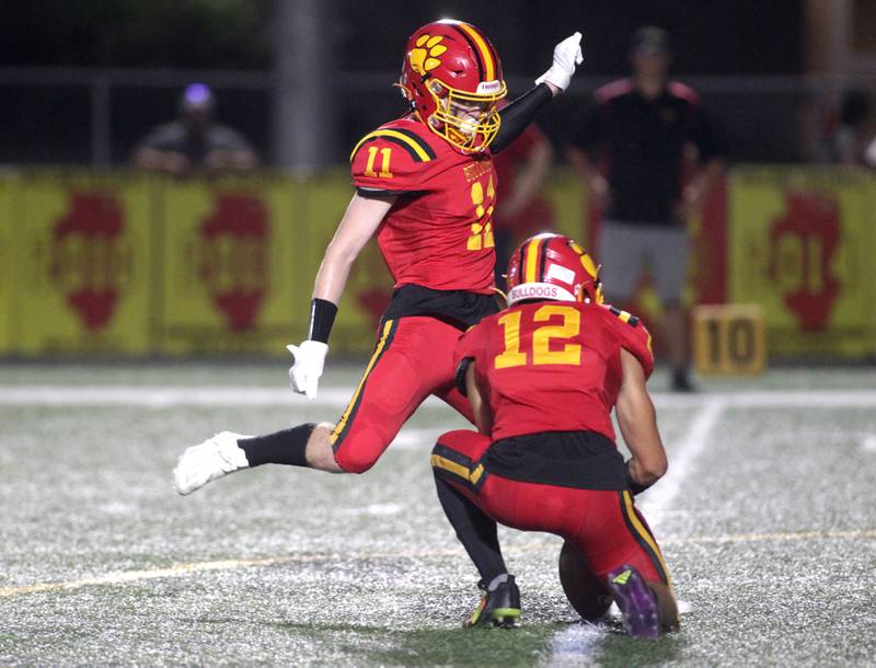 Batavia’s Patrick McNamara kicks an extra point held by Luke Alwin during the season-opener against Phillips in Batavia on Friday, Aug. 25, 2023.