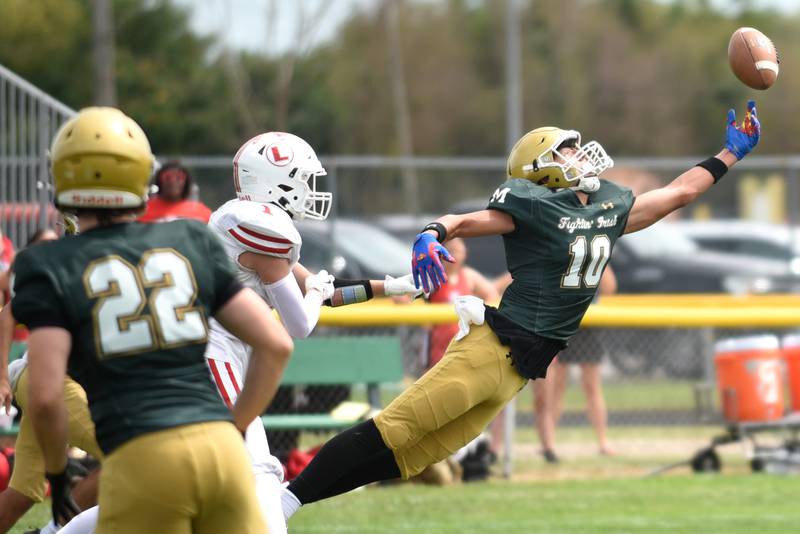 Bishop McNamara's Coen Demack, right, extends in attempt to intercept a pass during the Fightin' Irish's home game against Lawrenceville Saturday, Aug. 30, 2025.