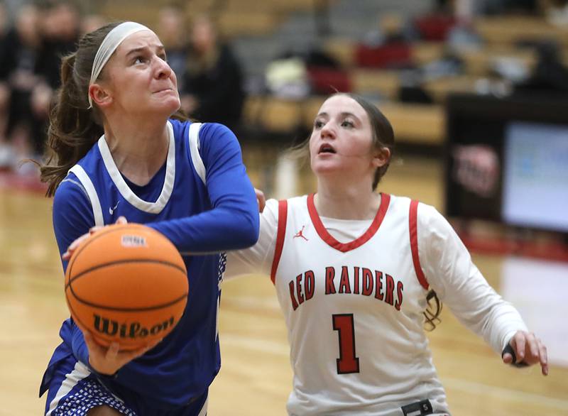 Burlington Central's Julia Scheuer drives to the basket against Huntley's Lana Hobday during a Fox Valley Conference girls basketball game on Tuesday Jan. 13, 2026, at Huntley High School.