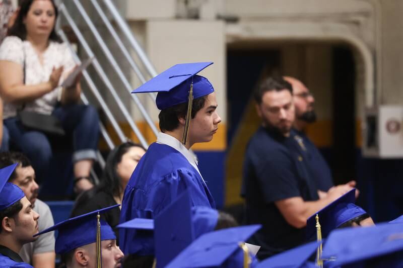 A graduate stands in recognition at the Joliet Central Class of 2023 Commencement Ceremony on Saturday, May 20, 2023, in Joliet.