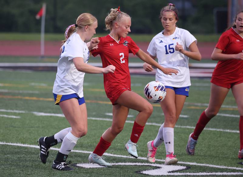 Timothy Christian's Ella Becvar splits two Johnsburg players Thursday, June 5, 2025, during their IHSA Class 1A state semifinal game at North Central College in Naperville.