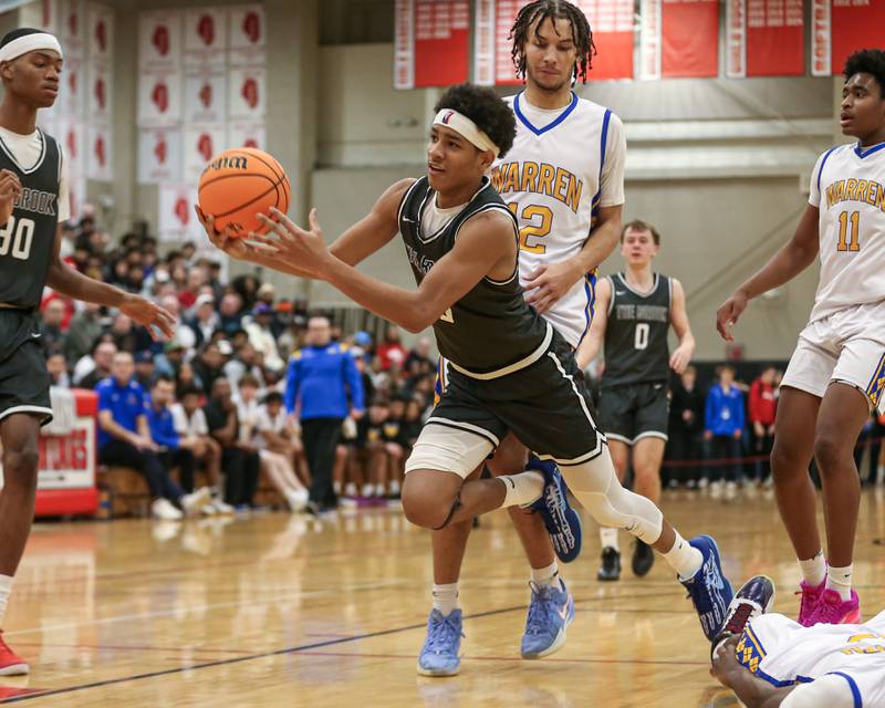 Bolingbrook's Davion Thompson (3) is fouled on a drive to the basket during their When Sides Collide Shootout basketball tournament matchup between Warren and Bolingbrook. Jan 25, 2025 in Lisle.