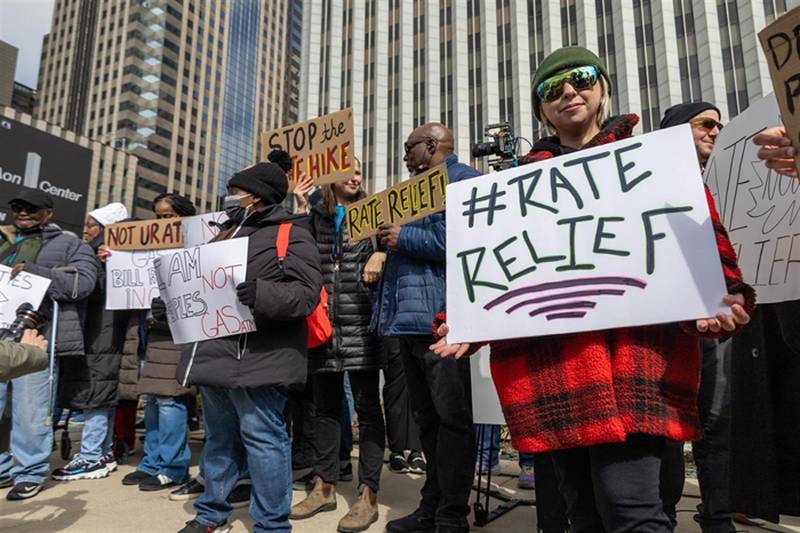 Yessenia Balcazar of the Southeast Environmental Task Force holds a sign at a March 27 protest of Peoples Gas’ proposed rate increase in downtown Chicago.