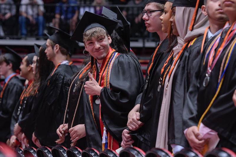 A graduate gives the thumbs up during the DeKalb High School graduation ceremony at the Convocation Center in DeKalb on Saturday, May 28, 2022.