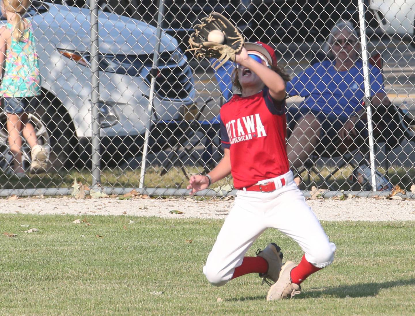 Ottawa American's Jack Markey catches a fly ball in the sun against Streator All Stars during the District 20 championship game on Sunday, July 14, 2024 at Washington Park in Peru.