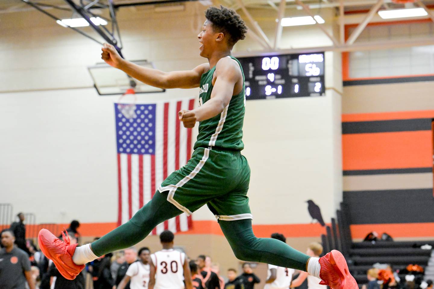 Glenbard West's Logan Glover (20) celebrates the Hilltoppers 56-51 win over DeKalb on Wednesday, Dec. 4, 2024.
