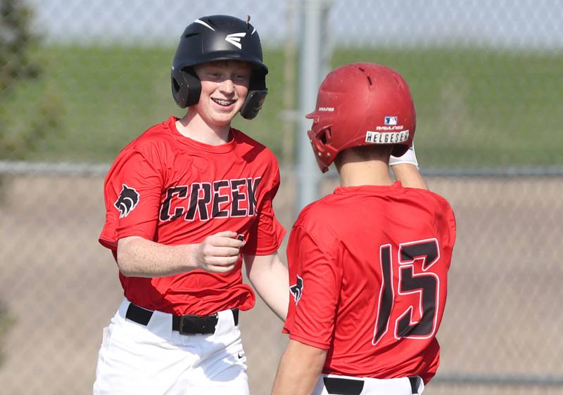 Indian Creek's Tyler Bogle is congratulated after scoring a run during their game against IMSA Monday, May 9, 2022, in Shabbona.