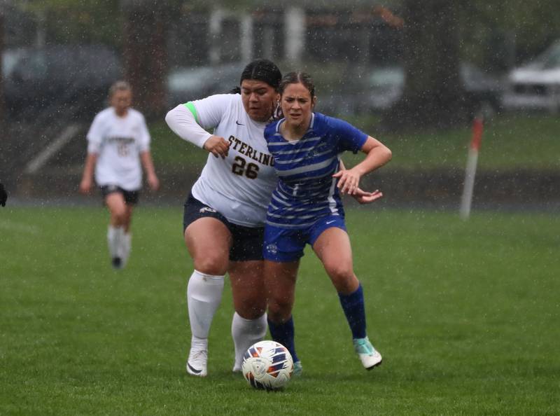 Princeton's Olivia Sandoval battles Sterling's Michelle Diaz (26) for the ball Thursday at Bryant Field. The Tigresses overcame the Golden Warriors and rain for a 3-1 victory.