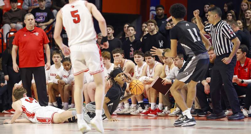 Kaneland's Isaiah Gipson (2) looks for an open teammate after diving and stealing the ball during the IHSA Class 3A boys basketball state semifinal Friday, March 13, 2026 at the State Farm Center in Champaign.