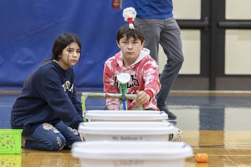 Seventh-grade teammates Valeria Hernandez and Carter Knight watch their pumpkin soar Thursday, Dec. 8, 2022. Students studied types of energy, gravity and air resistance while building their catapult for accuracy and trajectory.