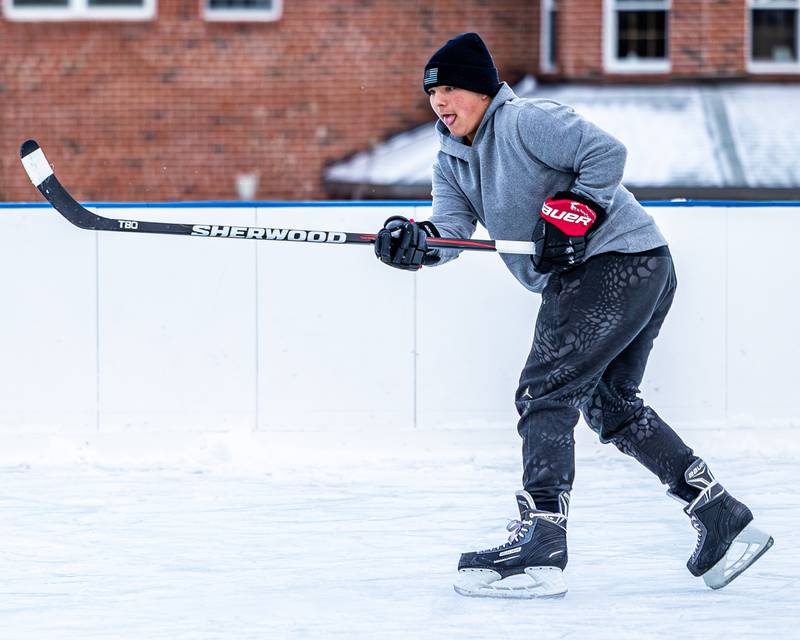 Timmy Dierks follows through after hitting puck at Schweickert Arena's Ice Rink on Tuesday, December 30, 2025, at Washington Park in Peru.
