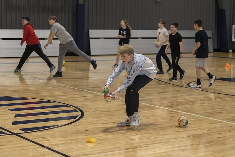 Players start a different game, Wednesday, March 8, 2023 at The Facility. A version of Dodgeball but bean bags are also slid across the floor so players need to jump and dive to avoid being tagged out.