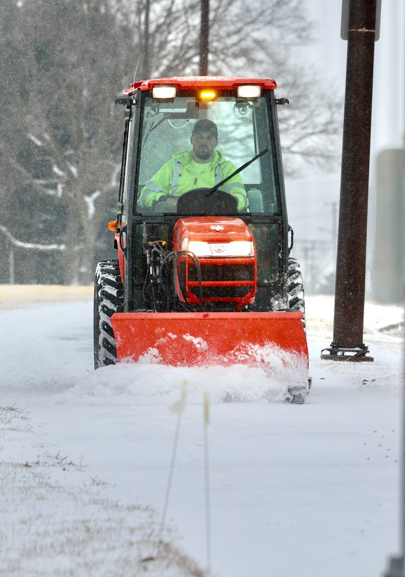A snowplow clears the sidewalk Wednesday, Feb. 12, 2025, near Hopkins Park in DeKalb.