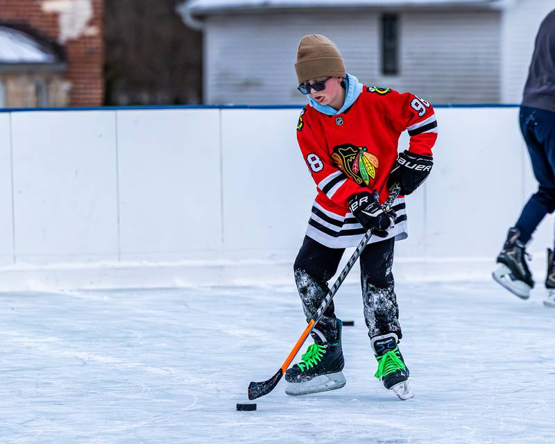 Weston Harris dribbles puck whilst iceskating at Schweickert Arena's Ice Rink on Tuesday, December 30, 2025, at Washington Park in Peru.