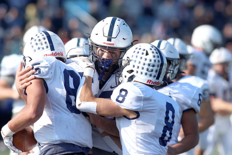 Cary-Grove’s Luca Vivaldelli, left, is greeted in the end zone after a touchdown reception against Highland Park in second-round IHSA Class 6A playoff action at Wolters Field in Highland Park Saturday.