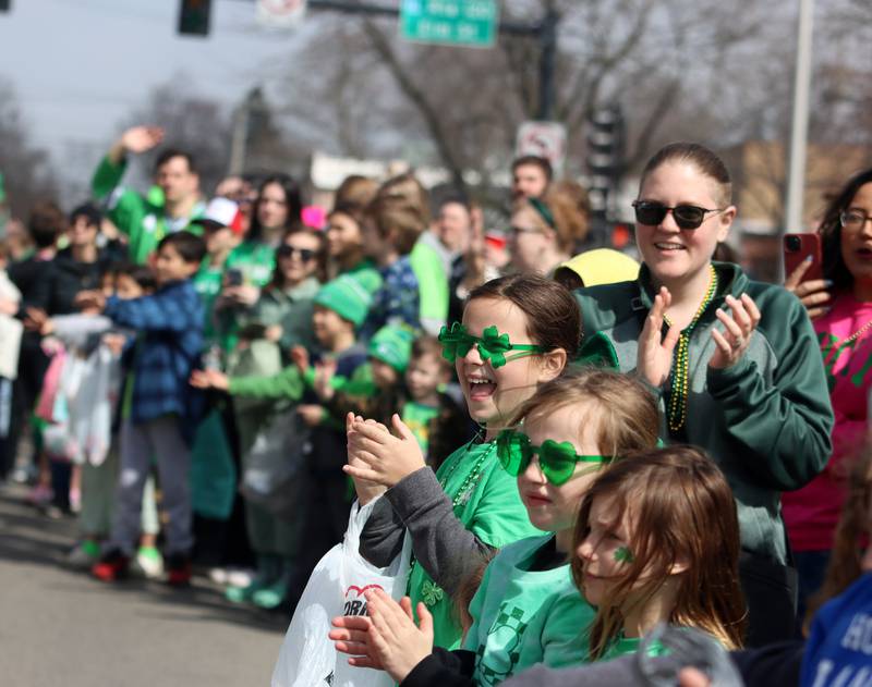 Children cheer along Green Street as the ShamROCKS the Fox Parade makes its way through McHenry on Saturday, March 15, 2025.