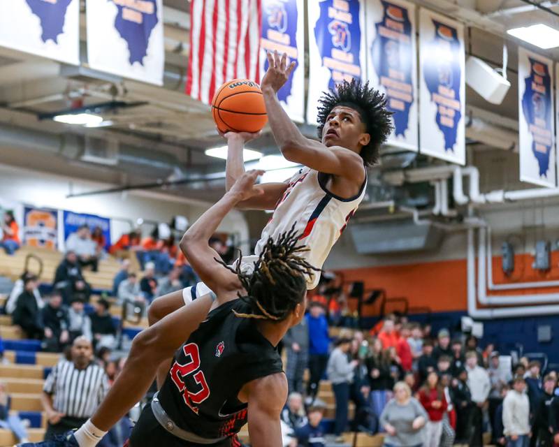 Oswego's Dasean Patton (23) puts up an off balanced shot during their basketball game between Yorkville at Oswego, Tuesday Dec 10, 2024 in Oswego.