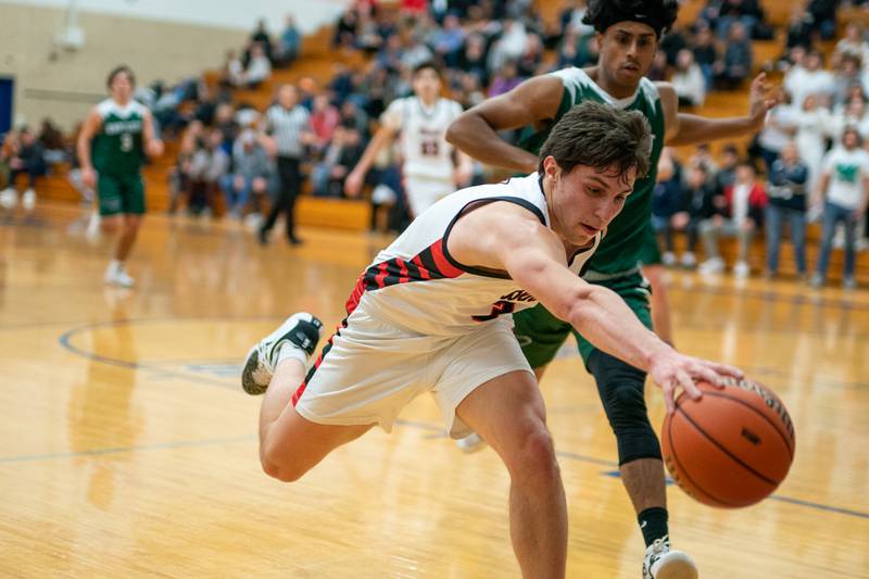 Benet’s Brady Kunka (3) lunges for.a loose ball during the 4A Addison Trail Regional final against Bartlett at Addison Trail High School in Addison on Friday, Feb 24, 2023.