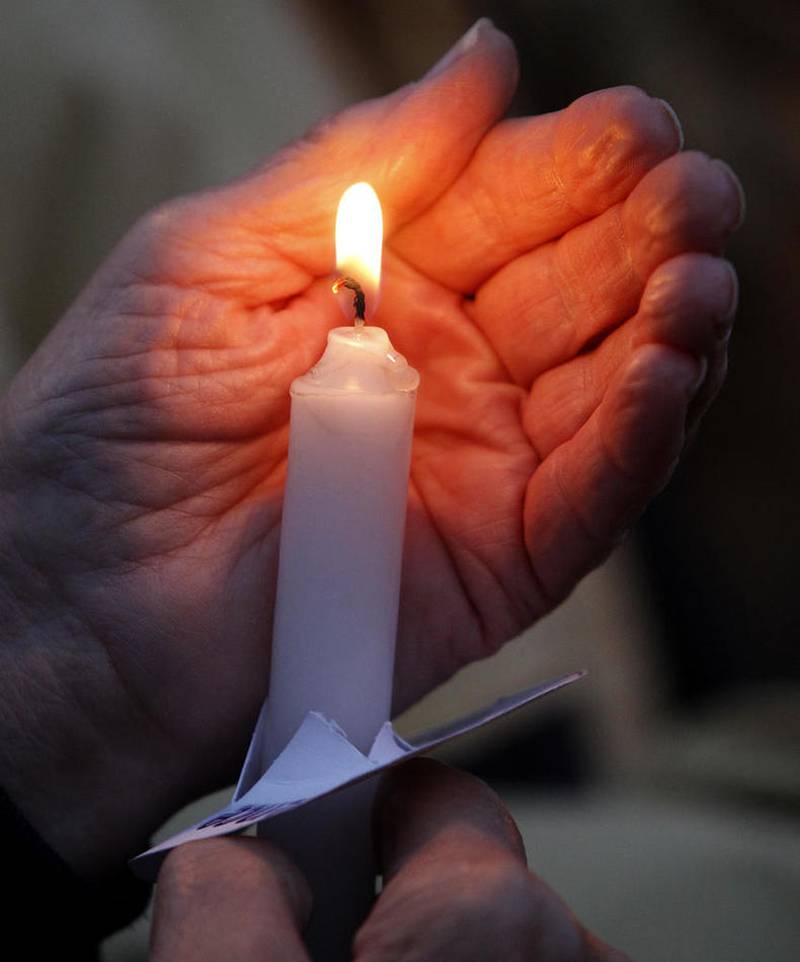 Matthew Apgar - mapgar@shawmedia.com
Norma Karsten of Marengo holds a lit candle during a vigil for domestic violence victims put on by Turning Point on Wednesday, Oct. 07, 2015 at Woodstock Square in Woodstock.