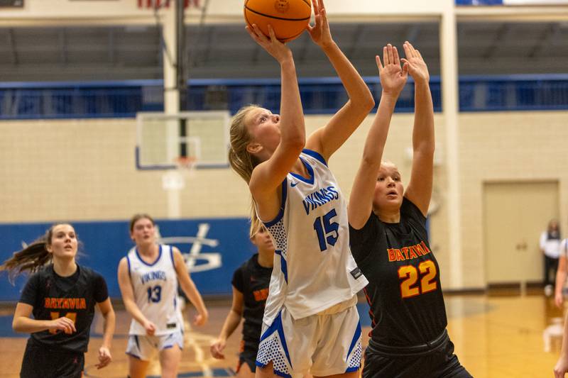 Geneva's Emma Peterson goes in for the shot past Batavia's Ali Thomas on Friday, Dec.19,2025 in Geneva.