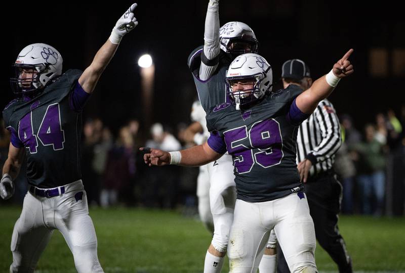 Wilmington's Declan Moran, left, and Zach Ohlund, right, signal a fumble recovery for Wilmington in the first quarter of a game against Coal City on Friday, October 24, 2025.