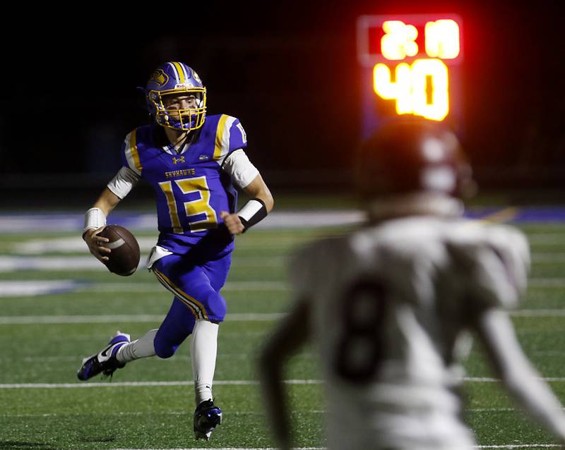 Johnsburg's Carter Block runs with the ball as the \rb defense closes in during a Kishwaukee River Conference football game on Friday, Sept. 12, 2025, at Johnsburg High School.