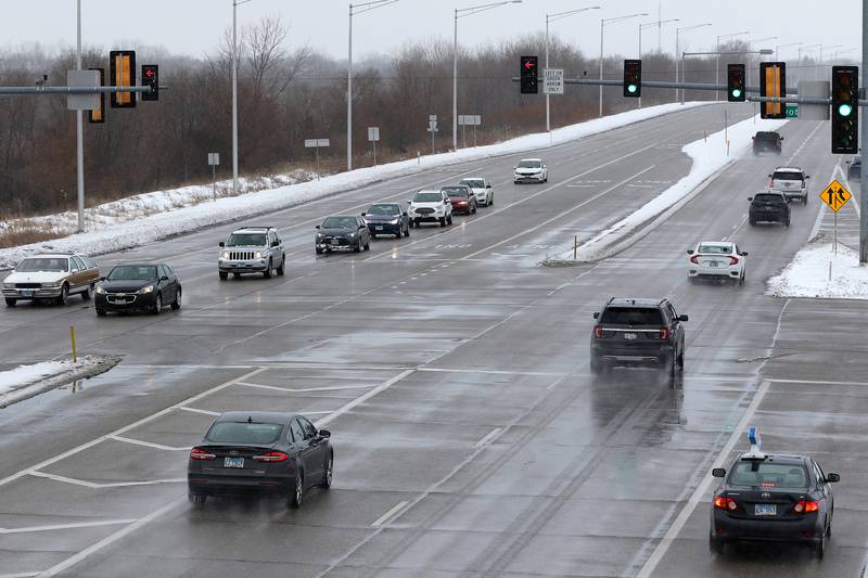 Cars navigate the slick conditions at the intersection of Rakow Road and Pyott Road on Tuesday, Jan. 26, 2021 in Crystal Lake.