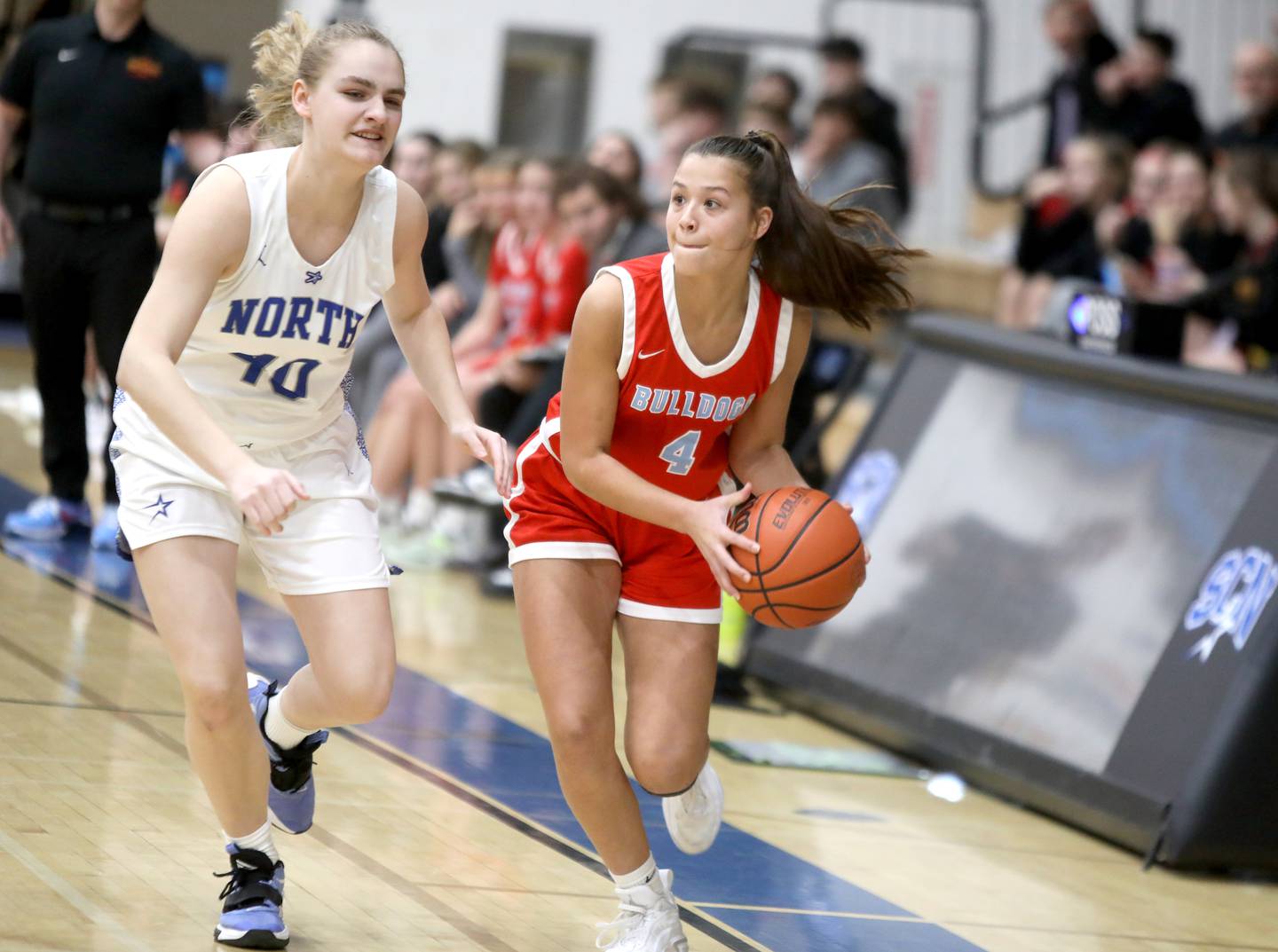 Batavia’s Addi Lowe (right) looks to pass the ball away from St. Charles North’s Elle Fuhr (left) during a game at St. Charles North on Tuesday, Feb. 7, 2023.