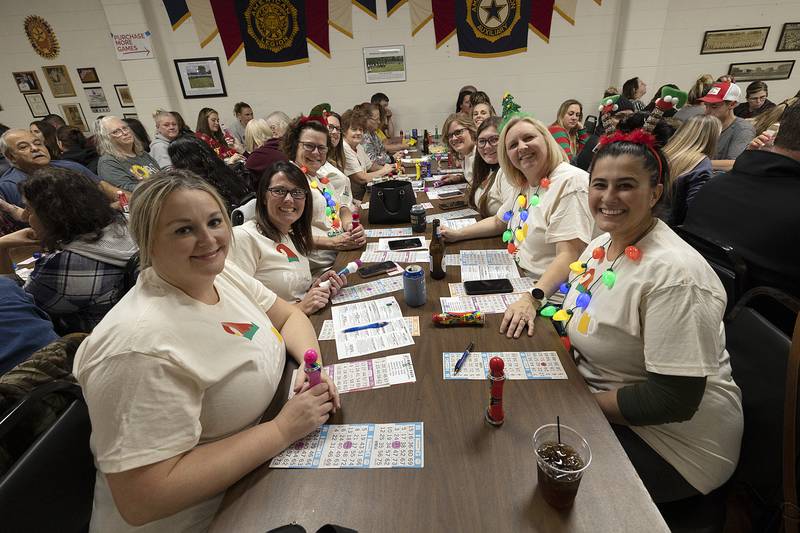 Wearing matching shirts, friends dress up for the fun bingo night Thursday, Nov. 21, 2024, in Rock Falls.